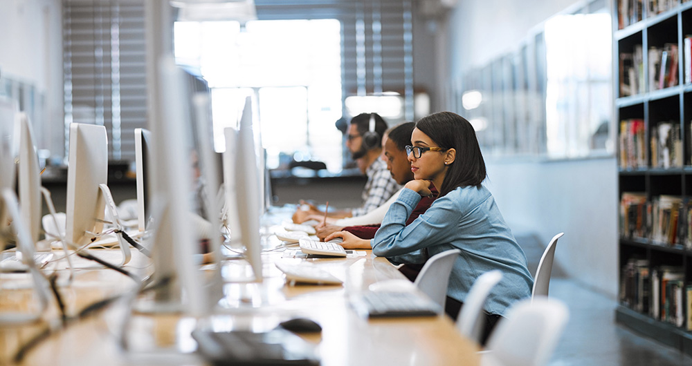 girl working at a desktop computer