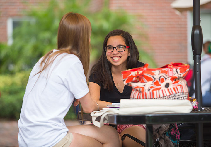 Students sitting a table, conversing