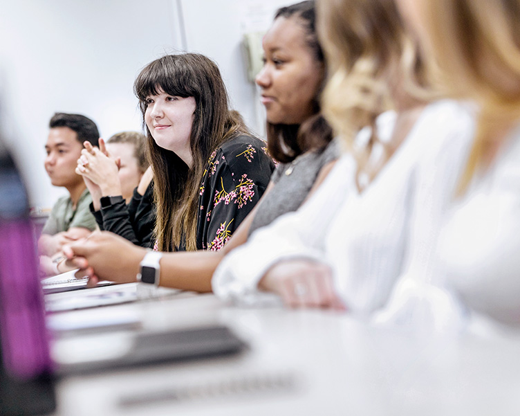 Students talking in a classroom.