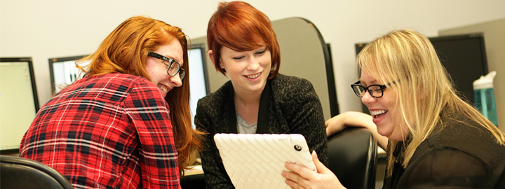 Students looking at a tablet