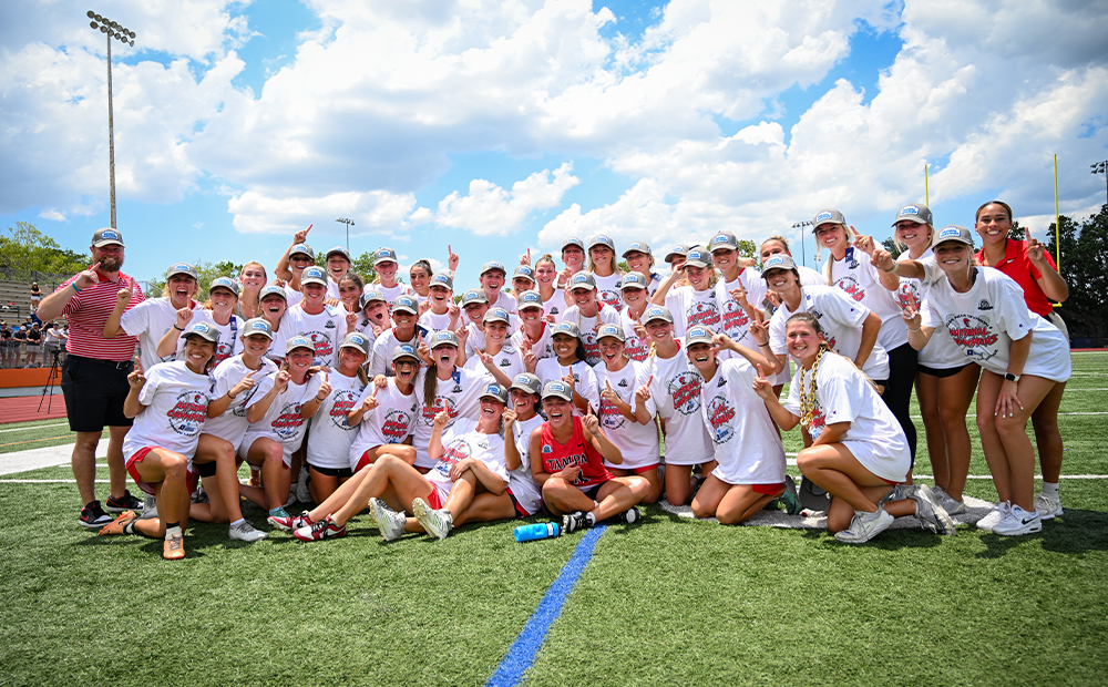 TEAM PHOTO OF WOMEN’S LACROSSE PLAYERS HOLDING UP THEIR INDEX FINGERS TO INDICATE THEY ARE NO.1