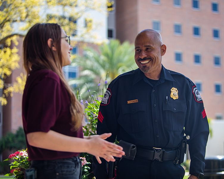 Campus Safety officer speaking with student