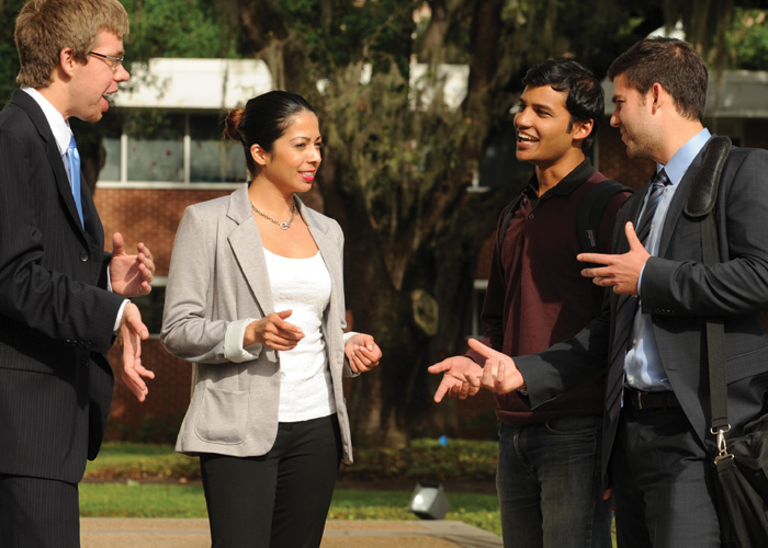 4 students talking to each other