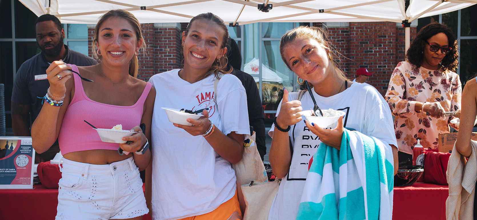 three girls eating ice cream at an orientation event