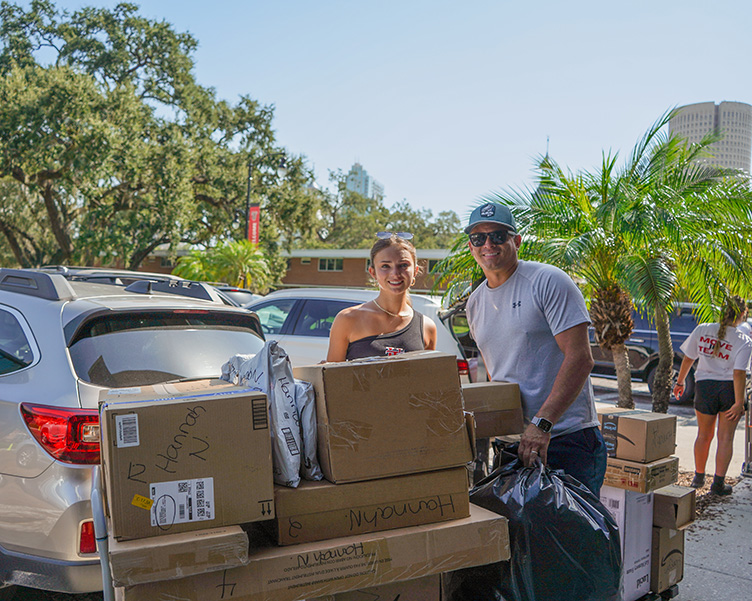 A daughter and father moving the daughter into her dorm.