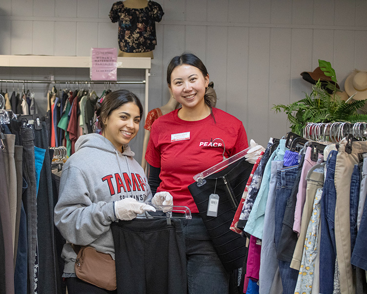 Students volunteeering with PEACE at a thrift store
