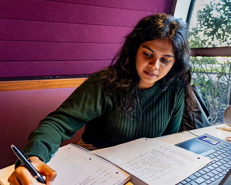 Woman studying and working on homework.