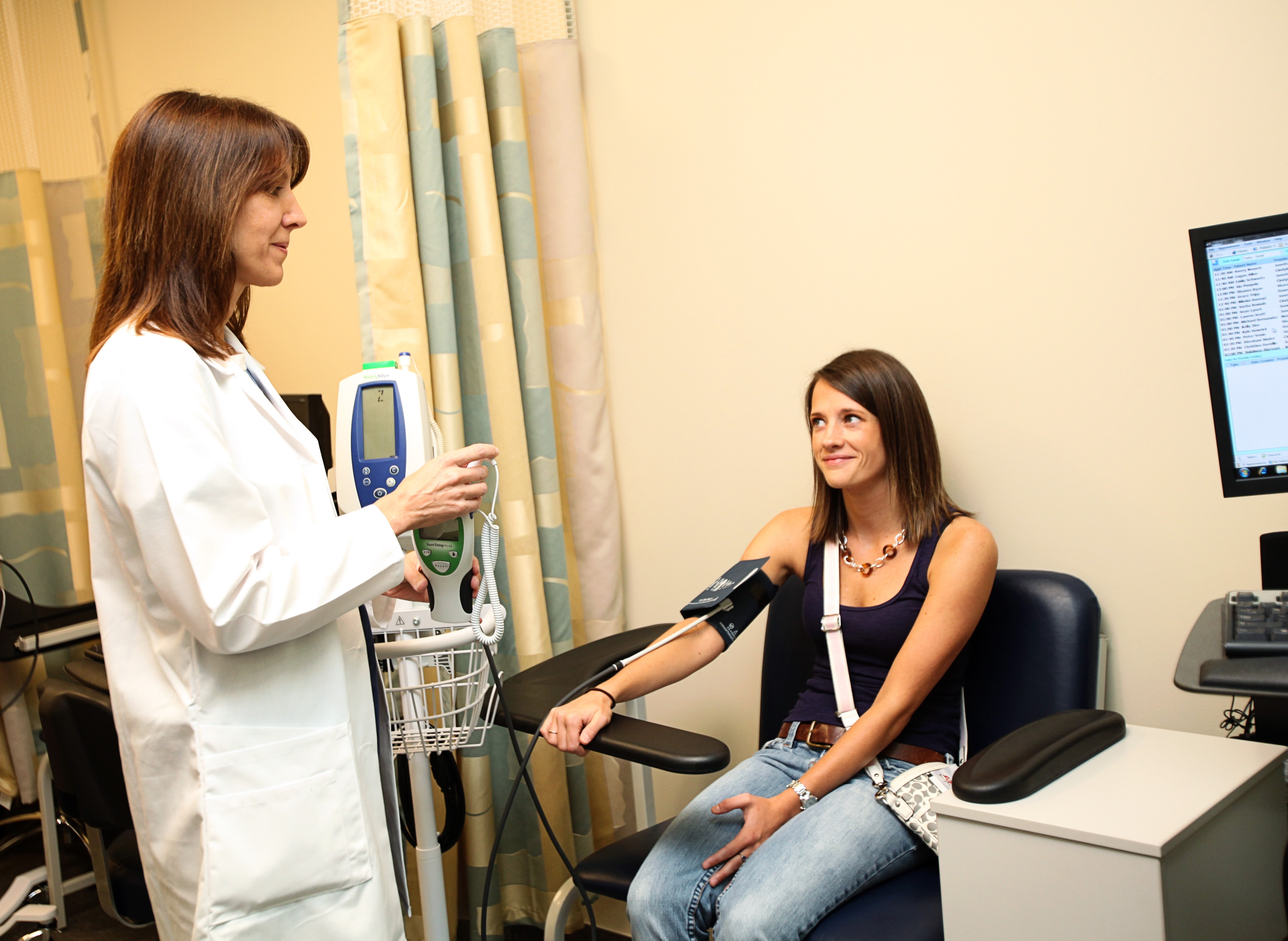 Doctor checking patient's blood pressure