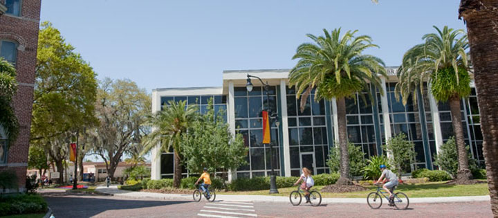 People riding bikes past the library