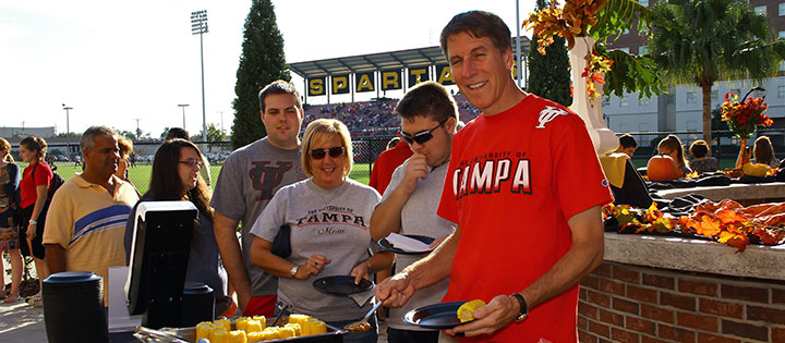 People standing outside in a buffet line