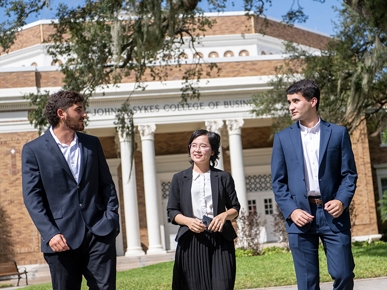 Grad students talking in front of the college of business