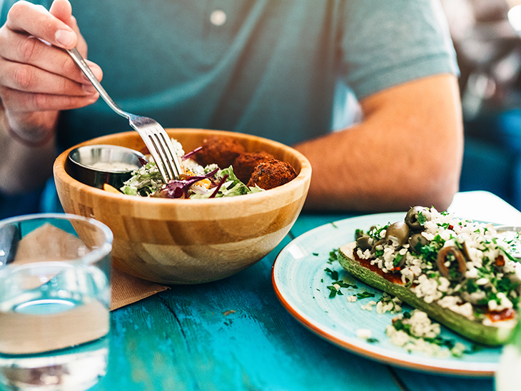 Person eating a falafel bowl