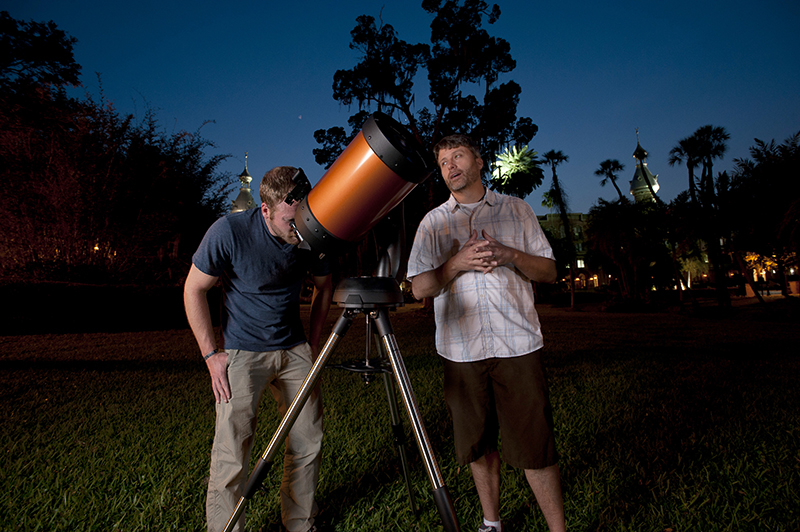 Associate professor Simon Schuler assists a student in using one of UT's computerized telescopes.